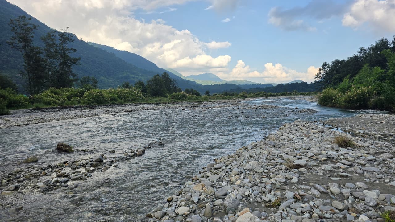 Wide riverbed with mountain views
